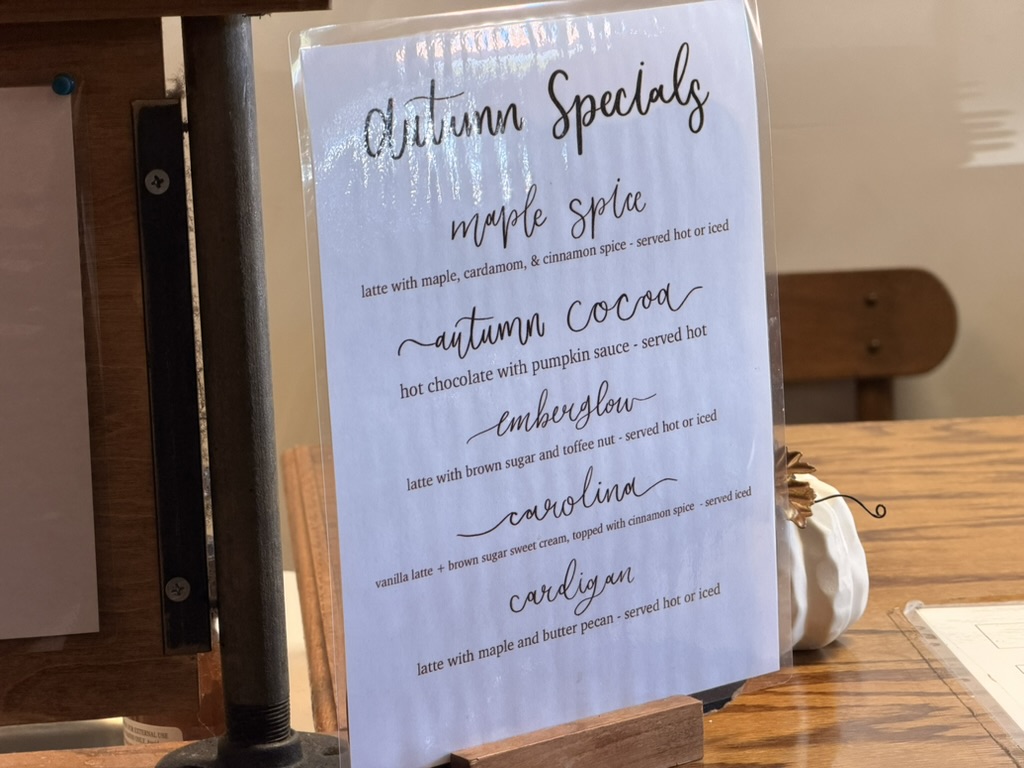 The printed Autumn Specials card on the counter at The Factory, beside a small white pumpkin.